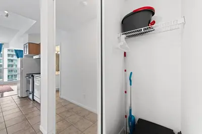 a room with a mop leaning against a door at Chic Fort York Studio Cozy Retreat in Downtown TO in Toronto