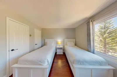 two white beds in a room with a window at Wintergreen 222 in Blue Mountains