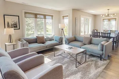 a living room with two couches and a table at Sierra Lane 218 in Blue Mountains