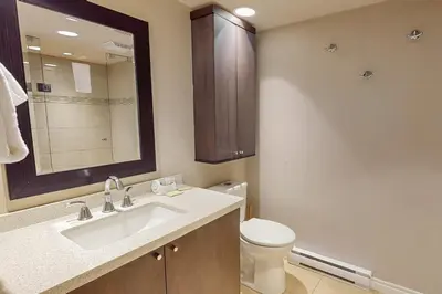 a bathroom with a sink and a toilet and a mirror at Sierra Lane 218 in Blue Mountains