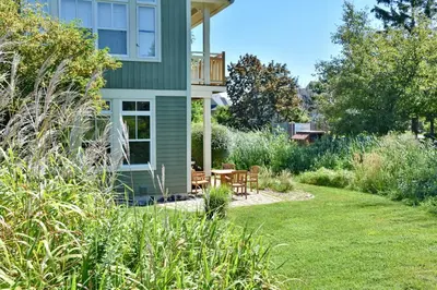 a garden with a house with a table and chairs at Sierra Lane 218 in Blue Mountains