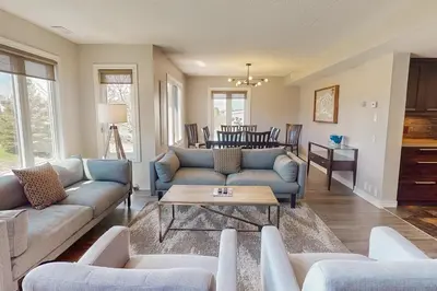 a living room with blue couches and a table at Sierra Lane 218 in Blue Mountains