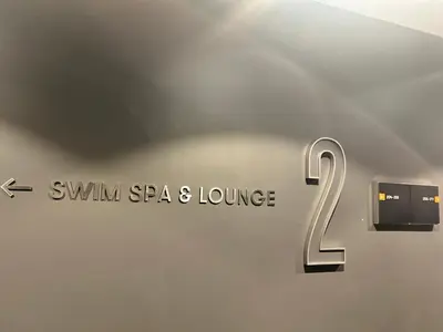 a wall with a sign that says swim spa and lounge at Luxury Condo with Hottub, outdoor firepit & Bowlin in Kitchener