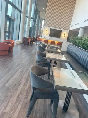 a lobby with couches and tables and chairs at Luxury Condo with Hottub, outdoor firepit & Bowlin in Kitchener