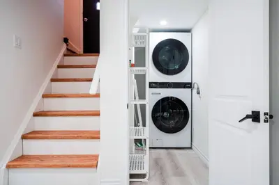 a laundry room with a washer and dryer at Bright & Cozy Home in the GTA (Basement Apartment) in Whitby
