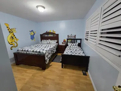 two twin beds in a room with blue walls at Peaceful Country Home on 25 Acres of Wooded Land in Alliston