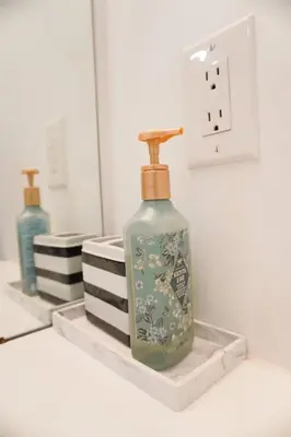 a green glass bottle sitting on top of a shelf at Entire 3 bedroom townhouse in Cambridge