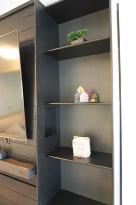 a closet with black shelves and a mirror at Entire 3 bedroom townhouse in Cambridge