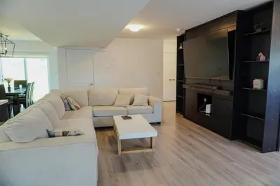 a living room with a couch and a table at Entire 3 bedroom townhouse in Cambridge