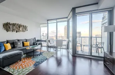 a living room with a couch and a table at High Floor 1 Bedroom Condo City View Downtown Toronto in Toronto