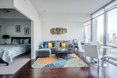 a living room with a couch and a bed and a table at High Floor 1 Bedroom Condo City View Downtown Toronto in Toronto