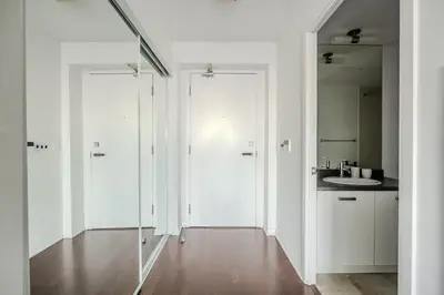 a white bathroom with a sink and a mirror at High Floor 1 Bedroom Condo City View Downtown Toronto in Toronto
