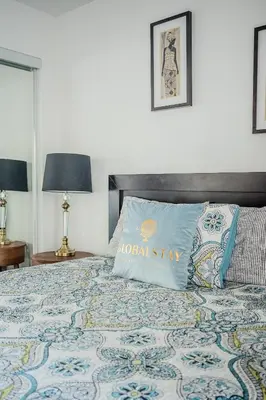 a bed with a blue pillow on top of it at High Floor 1 Bedroom Condo City View Downtown Toronto in Toronto
