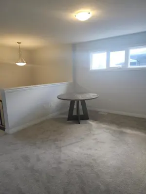 an empty room with a table and a window at Sunrise Villa in Fort Erie