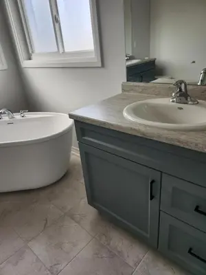 a bathroom with a tub and a sink and a bath tub at Sunrise Villa in Fort Erie