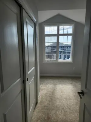 an empty room with a window and a door at Sunrise Villa in Fort Erie