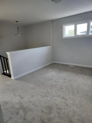 an empty room with a window and a white wall at Sunrise Villa in Fort Erie