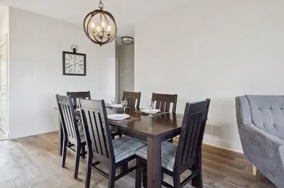 a dining room with a wooden table and chairs at Alpine Breeze Getaway at Blue in Blue Mountains