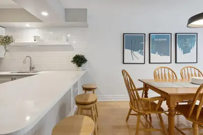 a kitchen and dining room with a table and chairs at Slopeside Ski In Ski Out Second Floor Condo in Blue Mountains