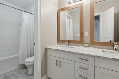a bathroom with a sink and a toilet and a mirror at Family Townhome in Historic Snowbridge in Blue Mountains