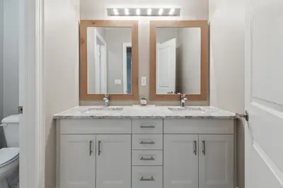 a bathroom with a sink and two mirrors at Family Townhome in Historic Snowbridge in Blue Mountains