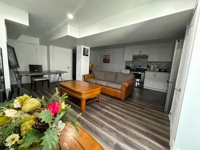a living room with a couch and a table at Basement Suite 2 bedroom s in Oshawa