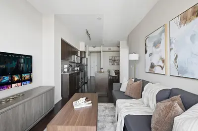 a living room with a couch and a table at Modern Lakeside 1BR Condo in Downtown Toronto in Toronto