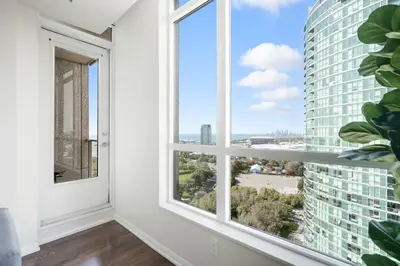 a room with a window with a view of the city at Modern Lakeside 1BR Condo in Downtown Toronto in Toronto