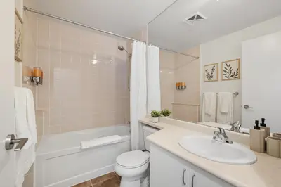 a bathroom with a sink and a toilet and a bath tub at Modern Lakeside 1BR Condo in Downtown Toronto in Toronto