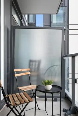 a patio with a table and a chair on a balcony at Modern Studio-Style Condo in Downtown Toronto in Toronto