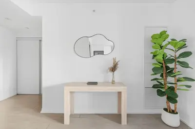 a table in a white room with a potted plant at Bright 2BR Condo w Patio Central Toronto Retreat in Toronto