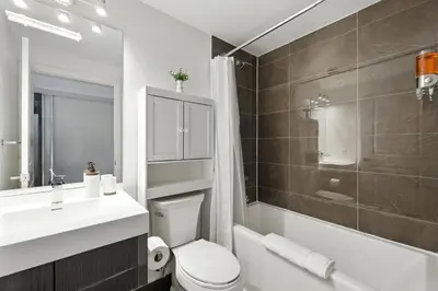 a bathroom with a toilet and a sink and a shower at Chic DT TO Studio Getaway Perfect for Couples in Toronto