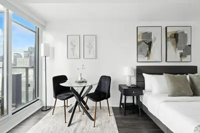 a bedroom with a bed and a table and chairs at Chic DT TO Studio Getaway Perfect for Couples in Toronto