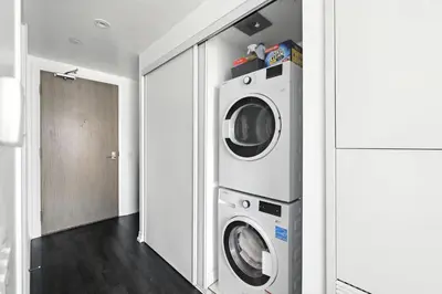 a laundry room with a washer and dryer at Chic DT TO Studio Getaway Perfect for Couples in Toronto