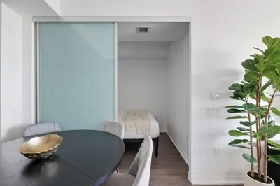 a dining room with a black table and chairs at Bright 2BR Downtown Toronto Condo in Toronto