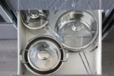 a group of metal pots and pans in a kitchen at Bright 2BR Downtown Toronto Condo in Toronto