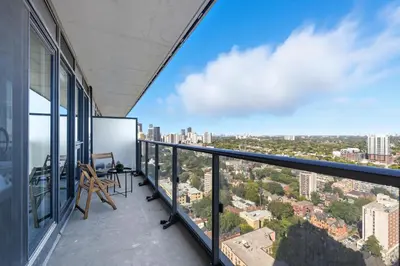 an apartment balcony with a view of the city at Bright 2BR Downtown Toronto Condo in Toronto