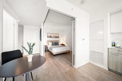 a room with a bed and a table and a mirror at City Living Downtown Retreat Perfect Getaway in Toronto