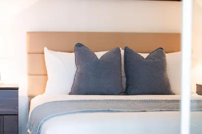 a bed with three pillows on top of it at City Living Downtown Retreat Perfect Getaway in Toronto