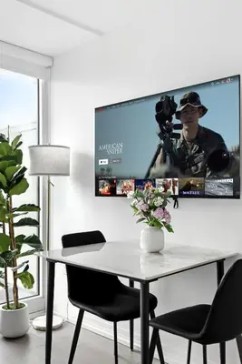a room with a table and a tv on the wall at Luxe Downtown Studio Near Eaton Centre & Transit in Toronto