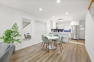a kitchen and dining room with a table and chairs at Stylish 3BR Urban Retreat near Christie Sleeps 6 in Toronto