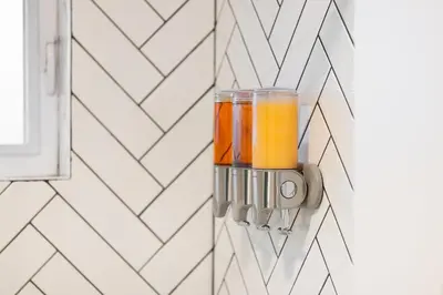 a glass jar of orange juice hanging on a wall at Stylish 3BR Urban Retreat near Christie Sleeps 6 in Toronto