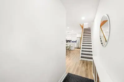 a room with a staircase and a mirror on the wall at Stylish 3BR Urban Retreat near Christie Sleeps 6 in Toronto