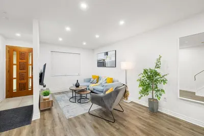 a living room with a couch and a table at Stylish 3BR Urban Retreat near Christie Sleeps 6 in Toronto