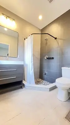 a bathroom with a shower and a toilet and a sink at Yonge Finch Subway Modern Suite with En Suite Bathroom in Toronto