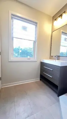 a bathroom with a sink and a window at Yonge Finch Subway Modern Suite with En Suite Bathroom in Toronto