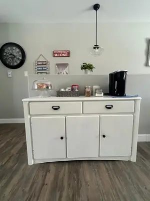 a white dresser in a room with a clock at The Klinck House in Collingwood