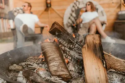 a man and a woman sitting next to a grill at The Klinck House in Collingwood