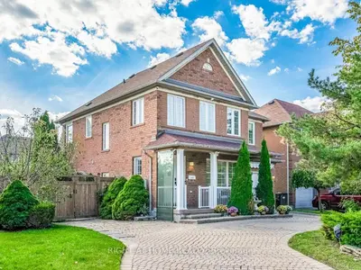 a brick house with a fence and trees at Pleasant stay Mississauga in Mississauga