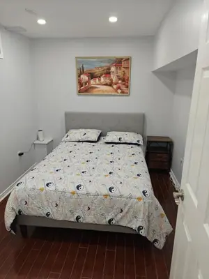 a bedroom with a bed and a painting on the wall at Pleasant stay Mississauga in Mississauga